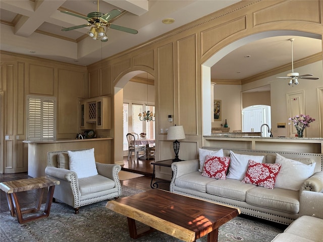 5812 Braemar Dr, Plano, TX 75093 - living room with a ceiling fan, arched walkways, a decorative wall, crown molding, and coffered ceiling