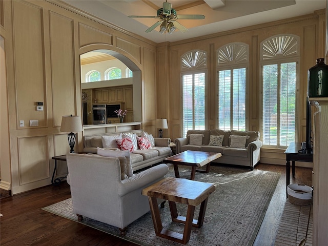 5812 Braemar Dr, Plano, TX 75093 - living area with a ceiling fan, healthy amount of natural light, dark wood-style flooring, and a decorative wall