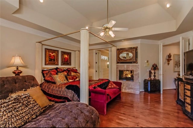 5812 Braemar Dr, Plano, TX 75093 - bedroom with a raised ceiling, a fireplace, wood finished floors, crown molding, and recessed lighting