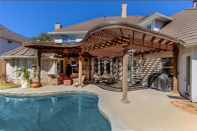 5812 Braemar Dr, Plano, TX 75093 - rear view of property featuring a pergola, an outdoor pool, an outdoor hangout area, and a patio