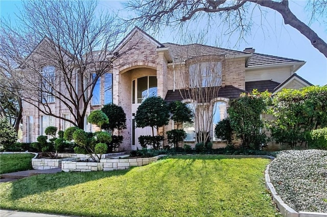 5812 Braemar Dr, Plano, TX 75093 - view of front of house with a front lawn, brick siding, and a chimney