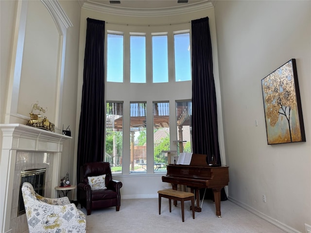 5812 Braemar Dr, Plano, TX 75093 - sitting room with carpet flooring, baseboards, a tiled fireplace, a high ceiling, and crown molding