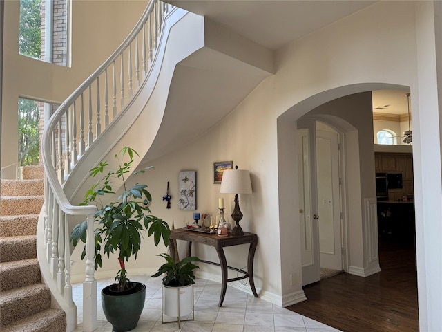 5812 Braemar Dr, Plano, TX 75093 - foyer entrance with stairs, arched walkways, and baseboards