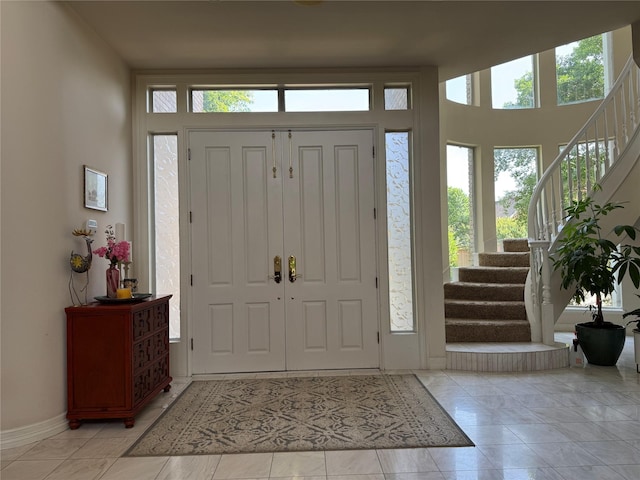 5812 Braemar Dr, Plano, TX 75093 - entrance foyer featuring stairs, healthy amount of natural light, and baseboards