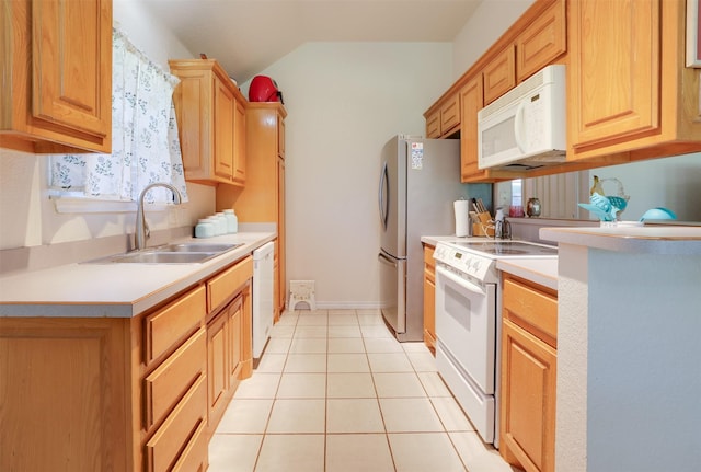 320 Mockingbird Ln, Springtown, TX 76082 - kitchen with white appliances, a sink, light countertops, light tile patterned floors, and vaulted ceiling