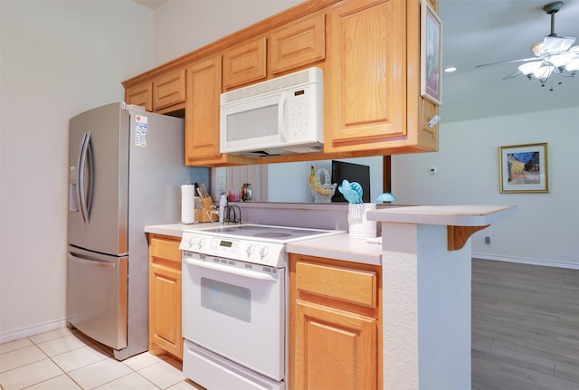 320 Mockingbird Ln, Springtown, TX 76082 - kitchen featuring white appliances, a ceiling fan, light countertops, and baseboards