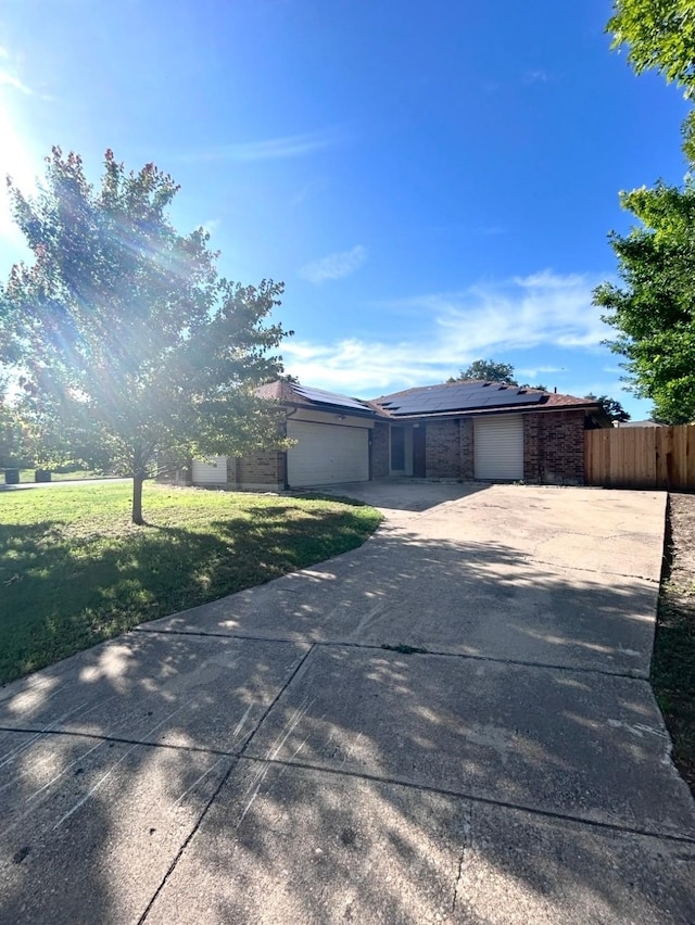 10058 Marblehead Ct, Fort Worth, TX 76108 - view of front of property featuring driveway, a garage, solar panels, and brick siding