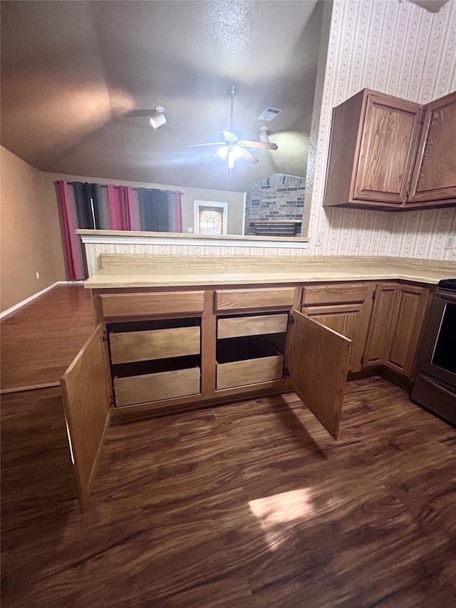 10058 Marblehead Ct, Fort Worth, TX 76108 - kitchen with lofted ceiling, light countertops, a ceiling fan, dark wood-style floors, and wallpapered walls