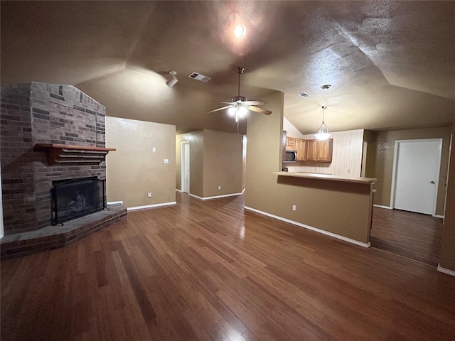 10058 Marblehead Ct, Fort Worth, TX 76108 - unfurnished living room featuring lofted ceiling, baseboards, dark wood-style flooring, a ceiling fan, and a brick fireplace