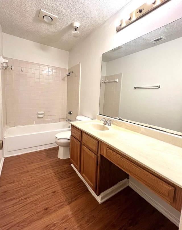 2617 Independence Dr, Mesquite, TX 75150 - full bathroom with toilet, wood finished floors, vanity, shower / bath combination, and a textured ceiling