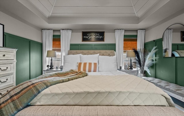 9505 Lost Trails Dr, Waco, TX 76712 - carpeted bedroom with a tray ceiling, ornamental molding, and a decorative wall