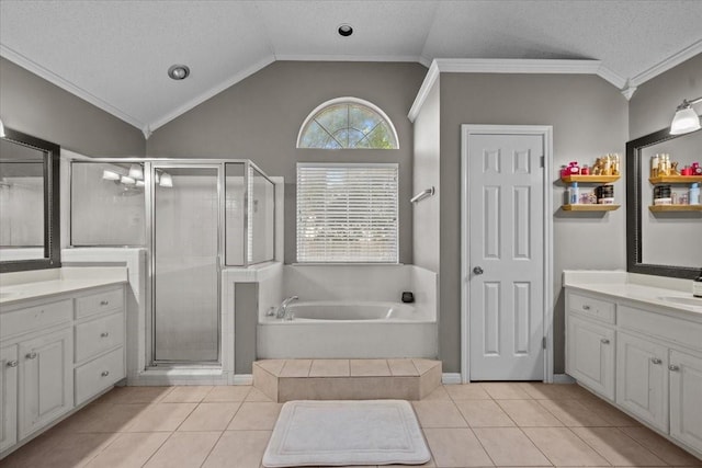 9505 Lost Trails Dr, Waco, TX 76712 - bathroom with tile patterned floors, two vanities, a bath, ornamental molding, and a stall shower