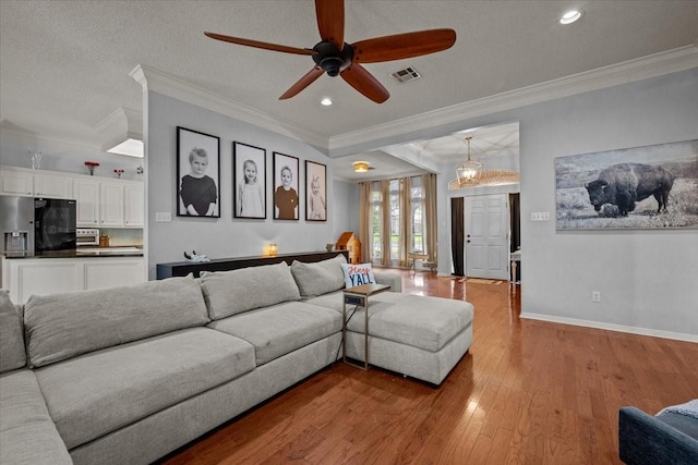 9505 Lost Trails Dr, Waco, TX 76712 - living room with ceiling fan, wood finished floors, crown molding, recessed lighting, and baseboards