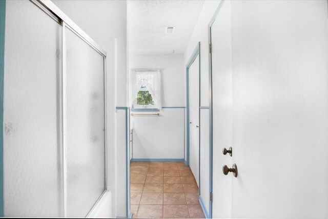 880 S Fm 779, Emory, TX 75440 - full bath with an enclosed shower, a textured ceiling, and baseboards