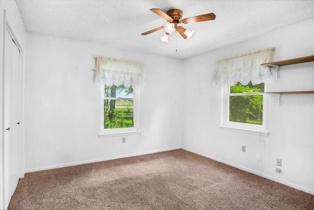 880 S Fm 779, Emory, TX 75440 - unfurnished bedroom featuring carpet flooring, a closet, a textured ceiling, baseboards, and a ceiling fan