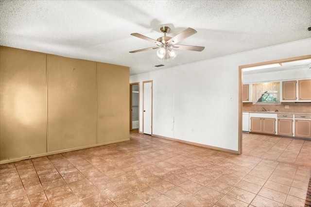 880 S Fm 779, Emory, TX 75440 - empty room featuring ceiling fan, a textured ceiling, and baseboards