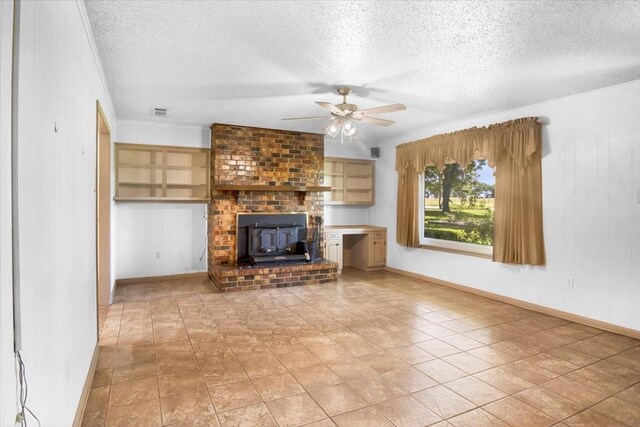 880 S Fm 779, Emory, TX 75440 - unfurnished living room with a textured ceiling, ceiling fan, a wood stove, baseboards, and light tile patterned floors