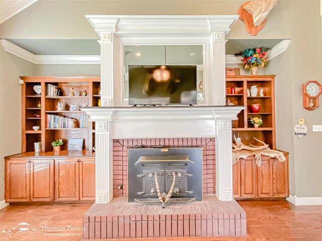 3226 County Road 360, Merkel, TX 79536 - living room featuring a brick fireplace, wood finished floors, ornamental molding, and baseboards