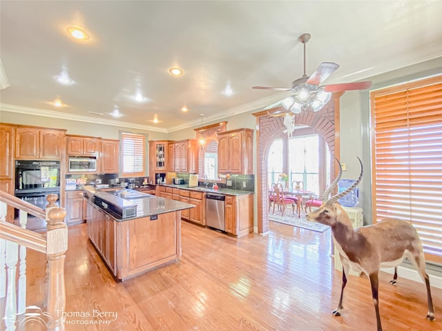 3226 County Road 360, Merkel, TX 79536 - kitchen with stainless steel appliances, a kitchen island, ornamental molding, a sink, and light wood finished floors