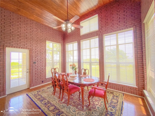 3226 County Road 360, Merkel, TX 79536 - dining room featuring brick wall, wood ceiling, ceiling fan, and wood finished floors