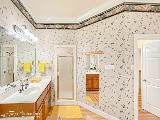 3226 County Road 360, Merkel, TX 79536 - full bathroom with wallpapered walls, ornamental molding, wood finished floors, a shower stall, and two vanities