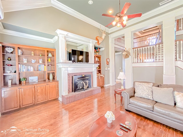 3226 County Road 360, Merkel, TX 79536 - living area with crown molding, light wood-style flooring, a ceiling fan, a brick fireplace, and high vaulted ceiling