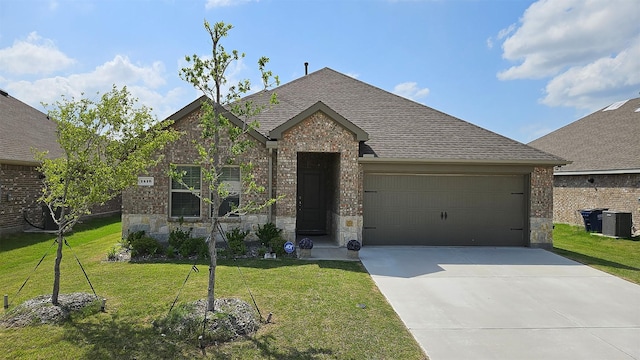 1416 Blossom Court Dr, Princeton, TX 75407 - view of front of home featuring central AC, an attached garage, concrete driveway, roof with shingles, and a front lawn