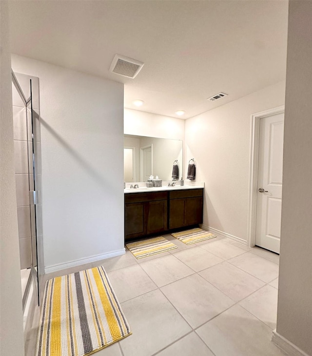 1416 Blossom Court Dr, Princeton, TX 75407 - bathroom with double vanity, an enclosed shower, baseboards, and tile patterned floors