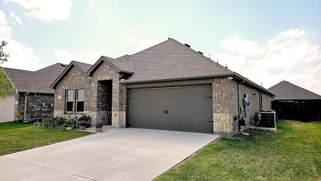 1416 Blossom Court Dr, Princeton, TX 75407 - view of front of property with stone siding, a garage, cooling unit, a front yard, and concrete driveway