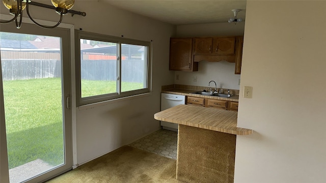 918 Maydelle Ln, Garland, TX 75042 - kitchen with a sink, dishwasher, light countertops, light floors, and a peninsula