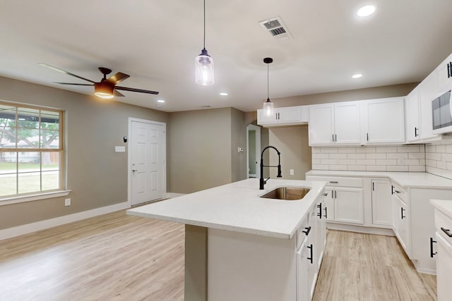 9726 Cushing Dr, Dallas, TX 75217 - kitchen featuring a sink, ceiling fan, tasteful backsplash, light wood-style floors, and recessed lighting