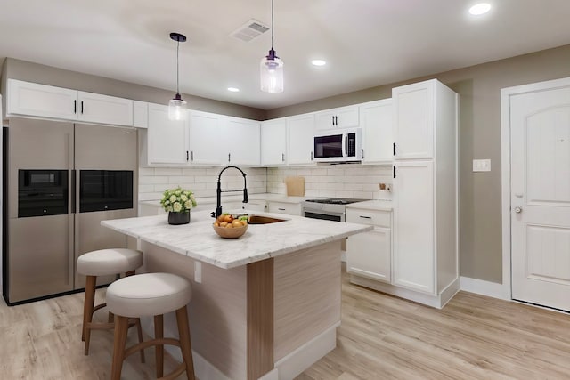 9726 Cushing Dr, Dallas, TX 75217 - kitchen with white appliances, a sink, white cabinetry, backsplash, and light wood-style floors