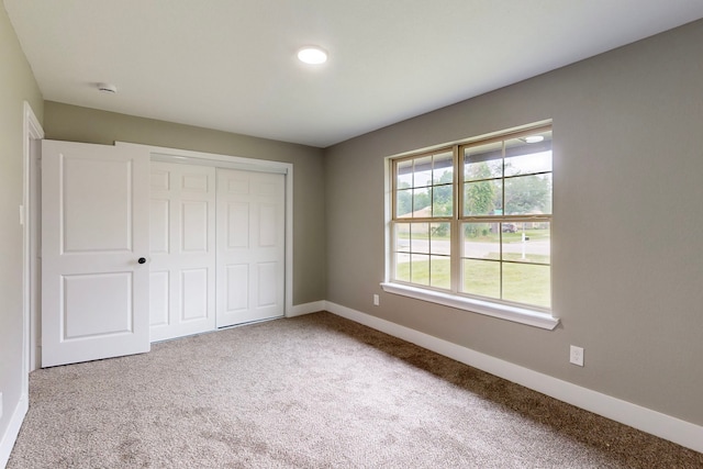9726 Cushing Dr, Dallas, TX 75217 - unfurnished bedroom with baseboards, carpet, and a closet