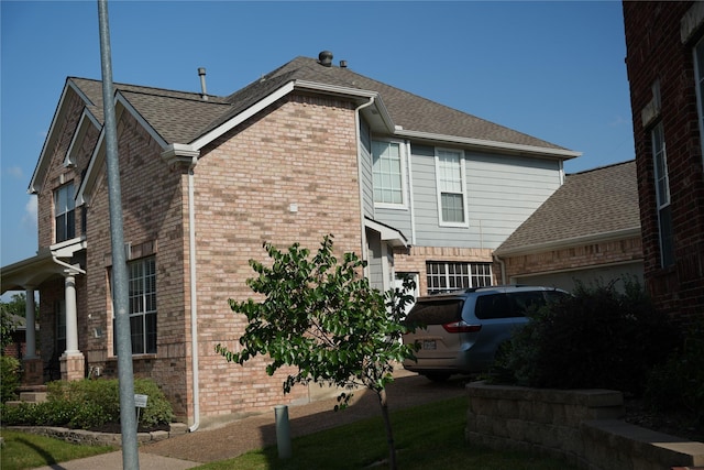 8300 Charleston St, Irving, TX 75063 - view of side of home featuring brick siding, a garage, and roof with shingles