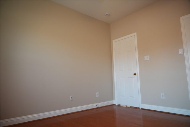 8300 Charleston St, Irving, TX 75063 - spare room featuring wood finished floors, baseboards, and a smoke detector