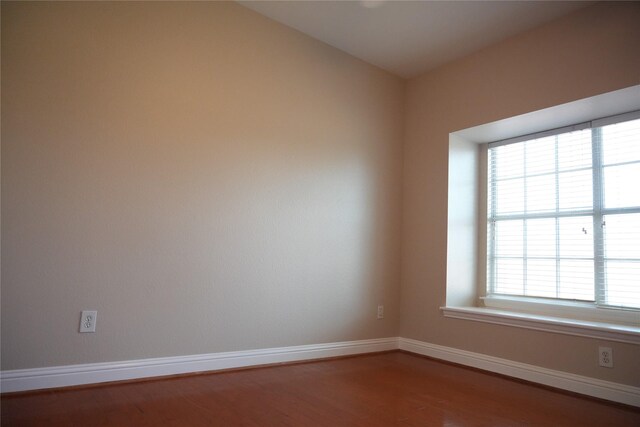 8300 Charleston St, Irving, TX 75063 - empty room with wood finished floors, healthy amount of natural light, and baseboards