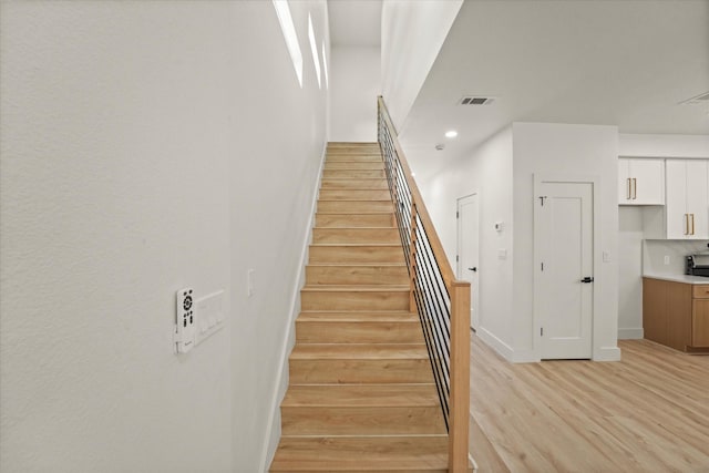 1336 Compton St, Dallas, TX 75203 - stairs featuring wood finished floors, baseboards, and recessed lighting