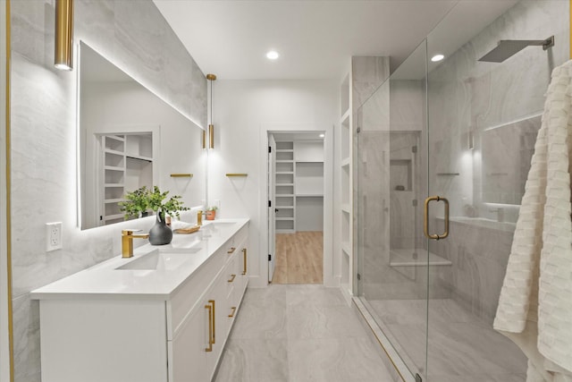 1336 Compton St, Dallas, TX 75203 - full bathroom with double vanity, a spacious closet, a stall shower, recessed lighting, and marble finish flooring