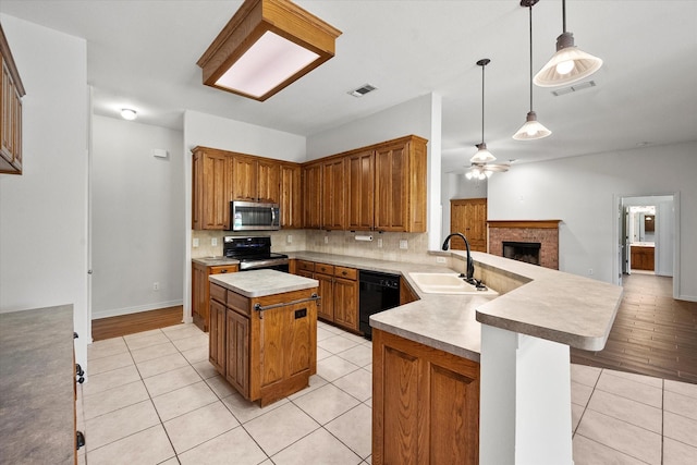 10208 W Rancho Diego Ln, Fort Worth, TX 76036 - kitchen featuring appliances with stainless steel finishes, a sink, light tile patterned floors, a peninsula, and decorative backsplash