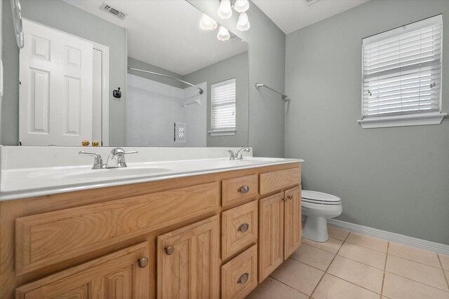 10208 W Rancho Diego Ln, Fort Worth, TX 76036 - bathroom featuring toilet, double vanity, tile patterned flooring, a shower, and baseboards