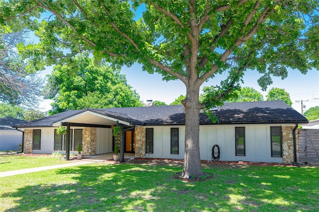 4458 Cardiff Ave, Fort Worth, TX 76133 - mid-century home with stone siding, a front yard, and a carport