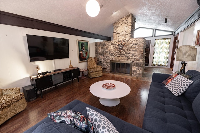 4458 Cardiff Ave, Fort Worth, TX 76133 - living area with vaulted ceiling, a textured ceiling, wood finished floors, and a stone fireplace