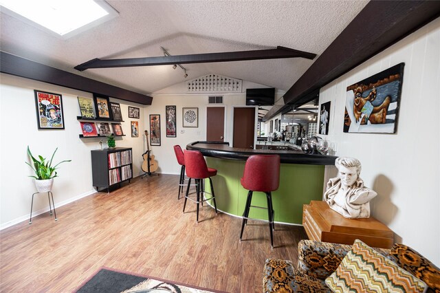 4458 Cardiff Ave, Fort Worth, TX 76133 - indoor bar featuring vaulted ceiling, wood finished floors, a textured ceiling, and baseboards