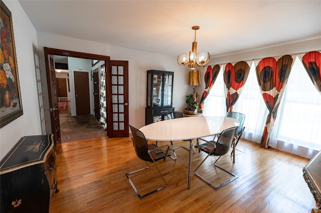 4458 Cardiff Ave, Fort Worth, TX 76133 - dining room with healthy amount of natural light, light wood-type flooring, and a chandelier