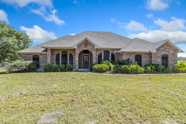 5282 Homeplace Ln, Kaufman, TX 75142 - french country inspired facade with a front yard, brick siding, and roof with shingles