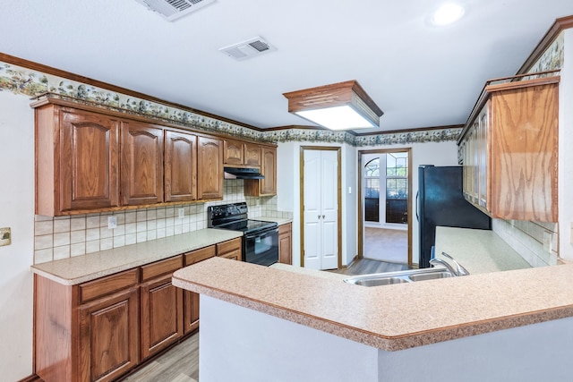 5282 Homeplace Ln, Kaufman, TX 75142 - kitchen with black appliances, a sink, under cabinet range hood, light countertops, and light wood-type flooring