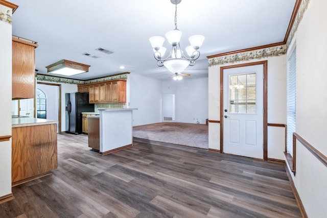 5282 Homeplace Ln, Kaufman, TX 75142 - kitchen featuring black fridge with ice dispenser, a chandelier, light countertops, dark wood finished floors, and a peninsula