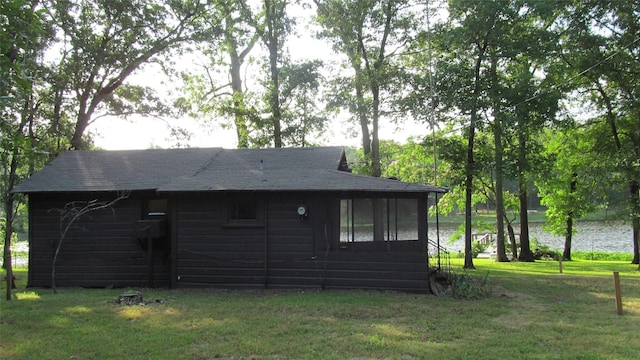 150 County Road 1699, Alba, TX 75410 - view of side of property featuring a yard, a shingled roof, a sunroom, and a water view
