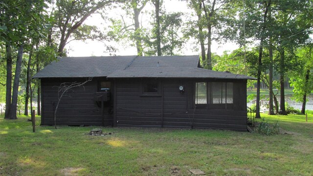 150 County Road 1699, Alba, TX 75410 - view of side of home featuring a yard and roof with shingles