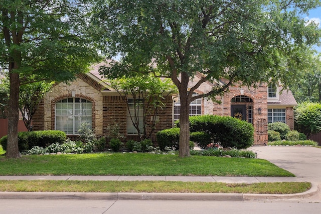 1869 Rio Blanco Dr, Frisco, TX 75033 - obstructed view of property with brick siding, a front yard, and stone siding